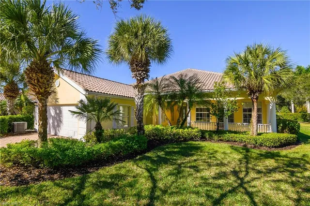 a front view of multi story residential apartment building with yard and green space