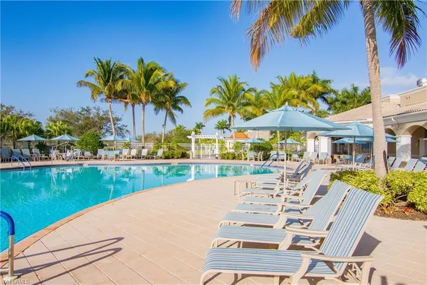 a view of a swimming pool with a table and chairs