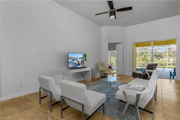 a living room with furniture a window and a flat screen tv