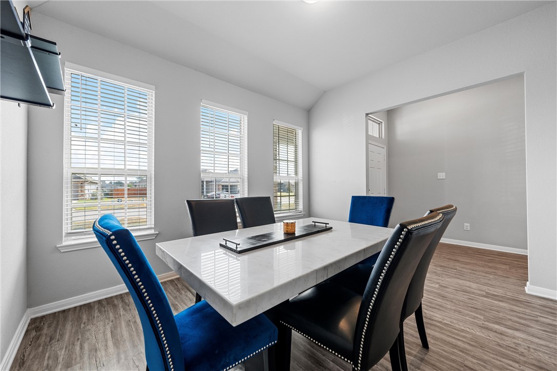 4016 Bravo Ranch Road Waco, TX 76705 - Photo 5 of 38 a view of a dining room with furniture window and wooden floor