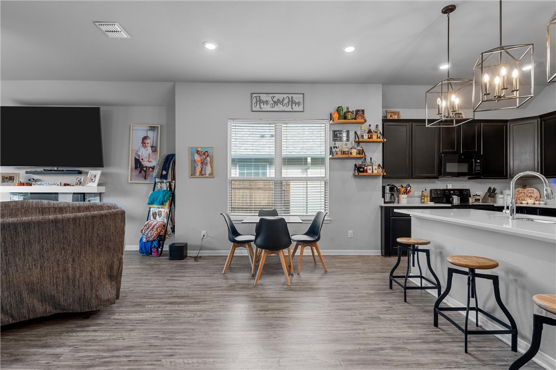 4016 Bravo Ranch Road Waco, TX 76705 - Photo 8 of 38 a view of a dining room with furniture kitchen and wooden floor