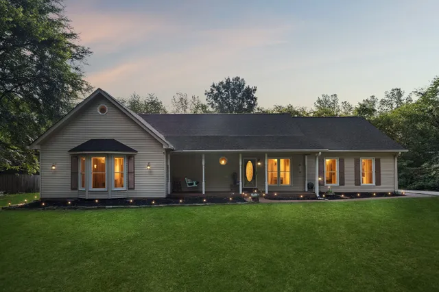 a front view of house with yard and green space