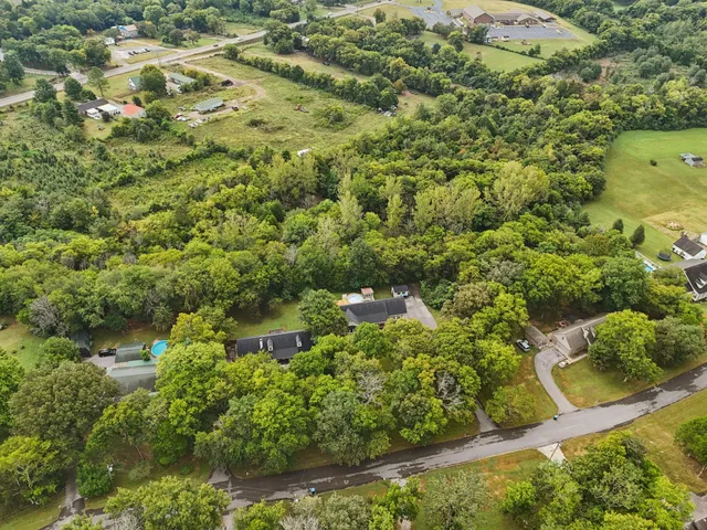 a kitchen with a refrigerator and a stove top oven