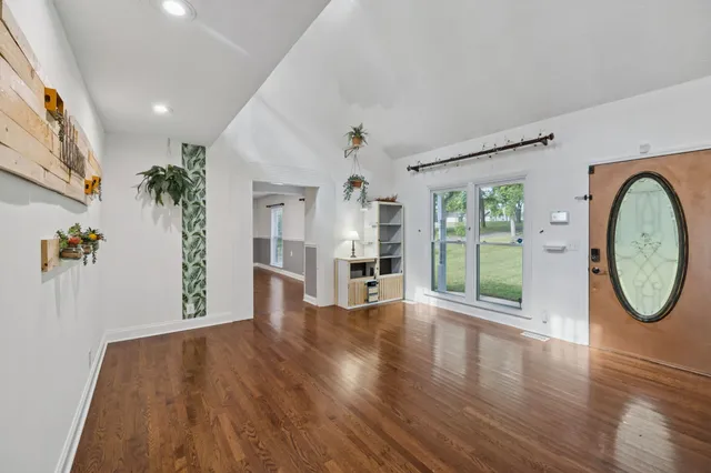 a view of a house with a yard and a garden