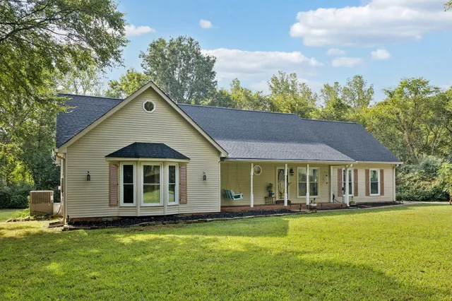 a front view of a house with a big yard