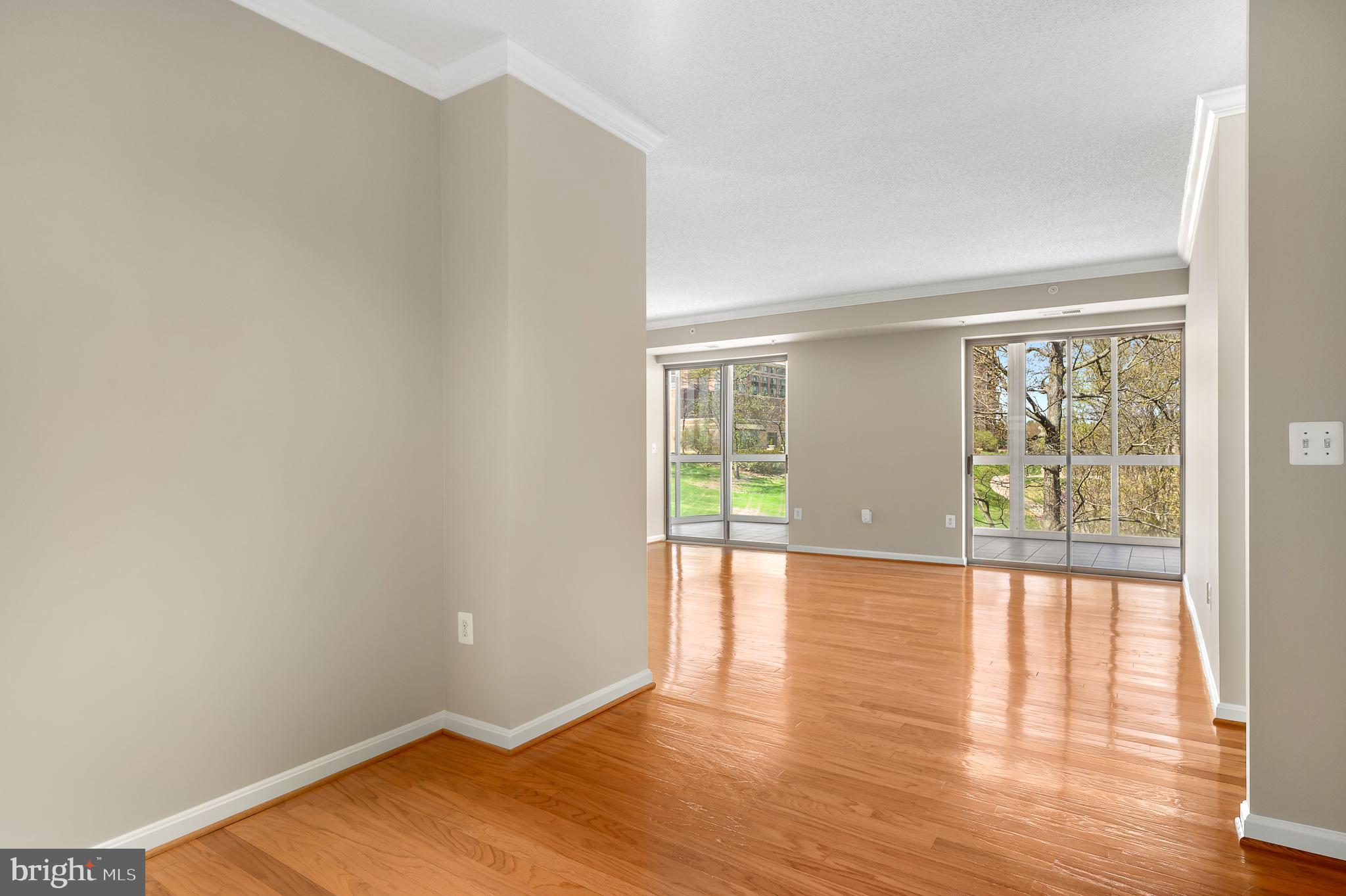 19355 Cypress Ridge Terrace, Unit 219 Leesburg, VA 20176 - Photo 11 of 42 wooden floor in an empty room with a window
