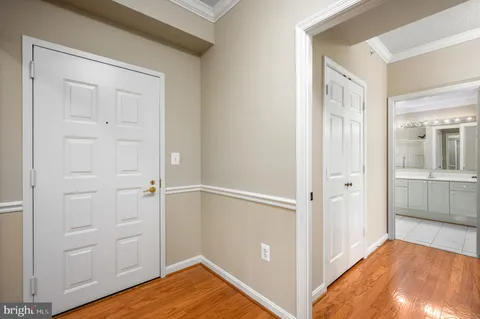 a view of a room with wooden floor and cabinet