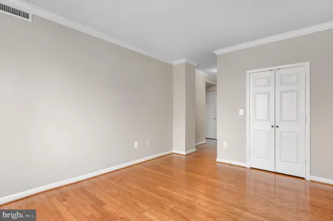 a view of an empty room and wooden floor