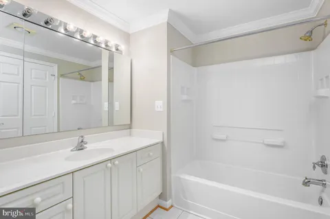 a bathroom with a bathtub a sink and mirror