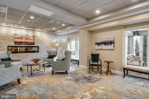 a work room with furniture and a flat screen tv