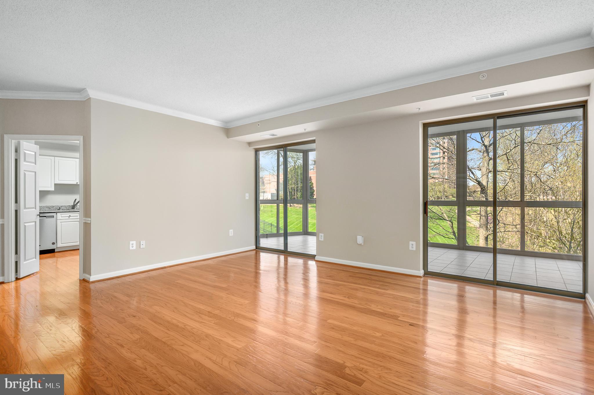 19355 Cypress Ridge Terrace, Unit 219 Leesburg, VA 20176 - Photo 4 of 42 wooden floor in an empty room with a window