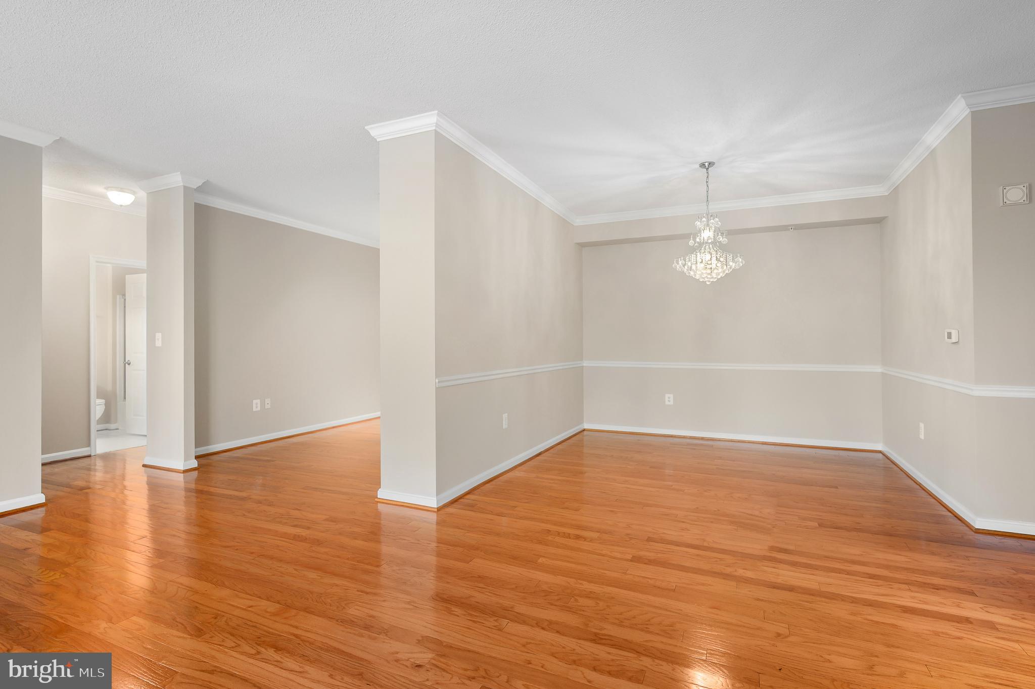 19355 Cypress Ridge Terrace, Unit 219 Leesburg, VA 20176 - Photo 7 of 42 a view of an empty room with wooden floor