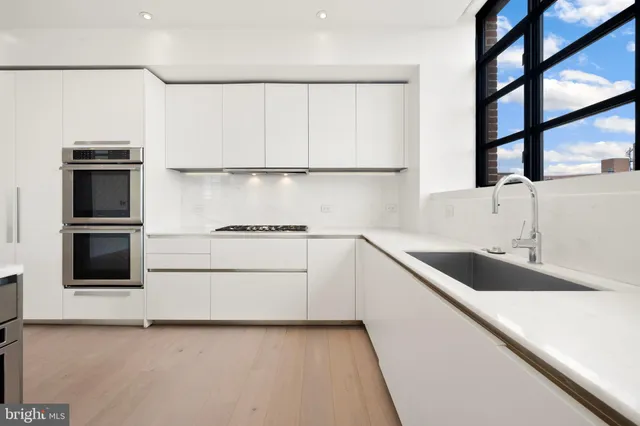 a kitchen with a refrigerator and a sink