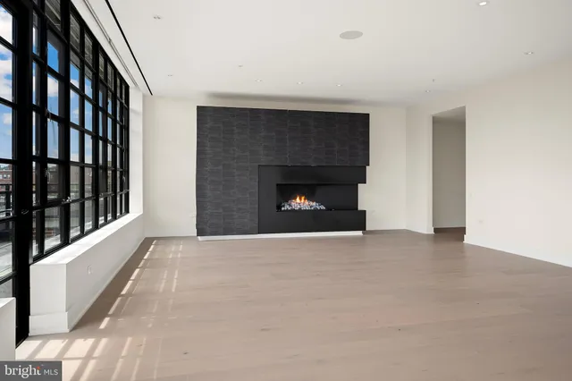 a view of an empty room with a fireplace