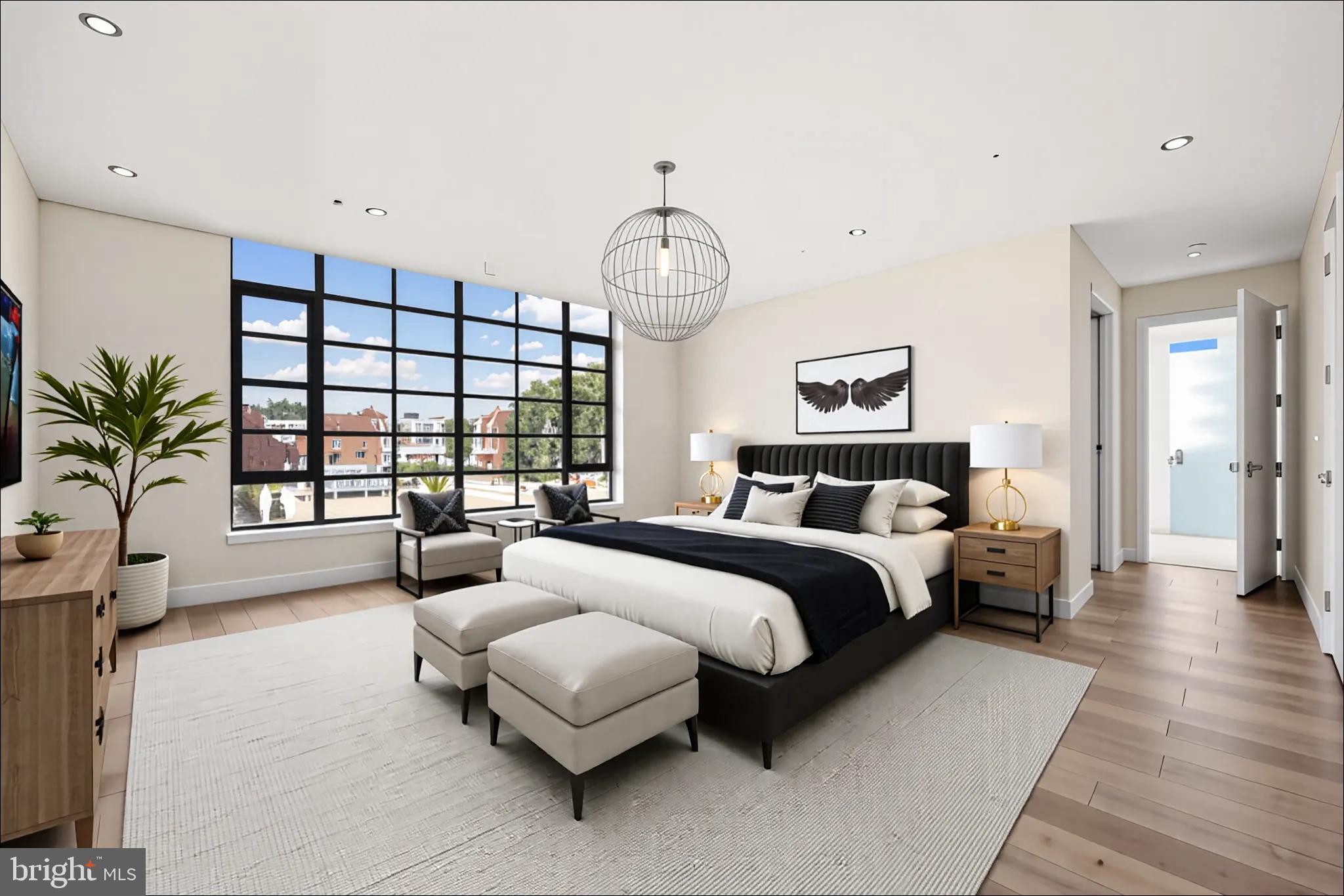 1055 Wisconsin Avenue Northwest, Unit 4E Washington, DC 20007 - Photo 17 of 58 a spacious bedroom with a bed a couch and a large window
