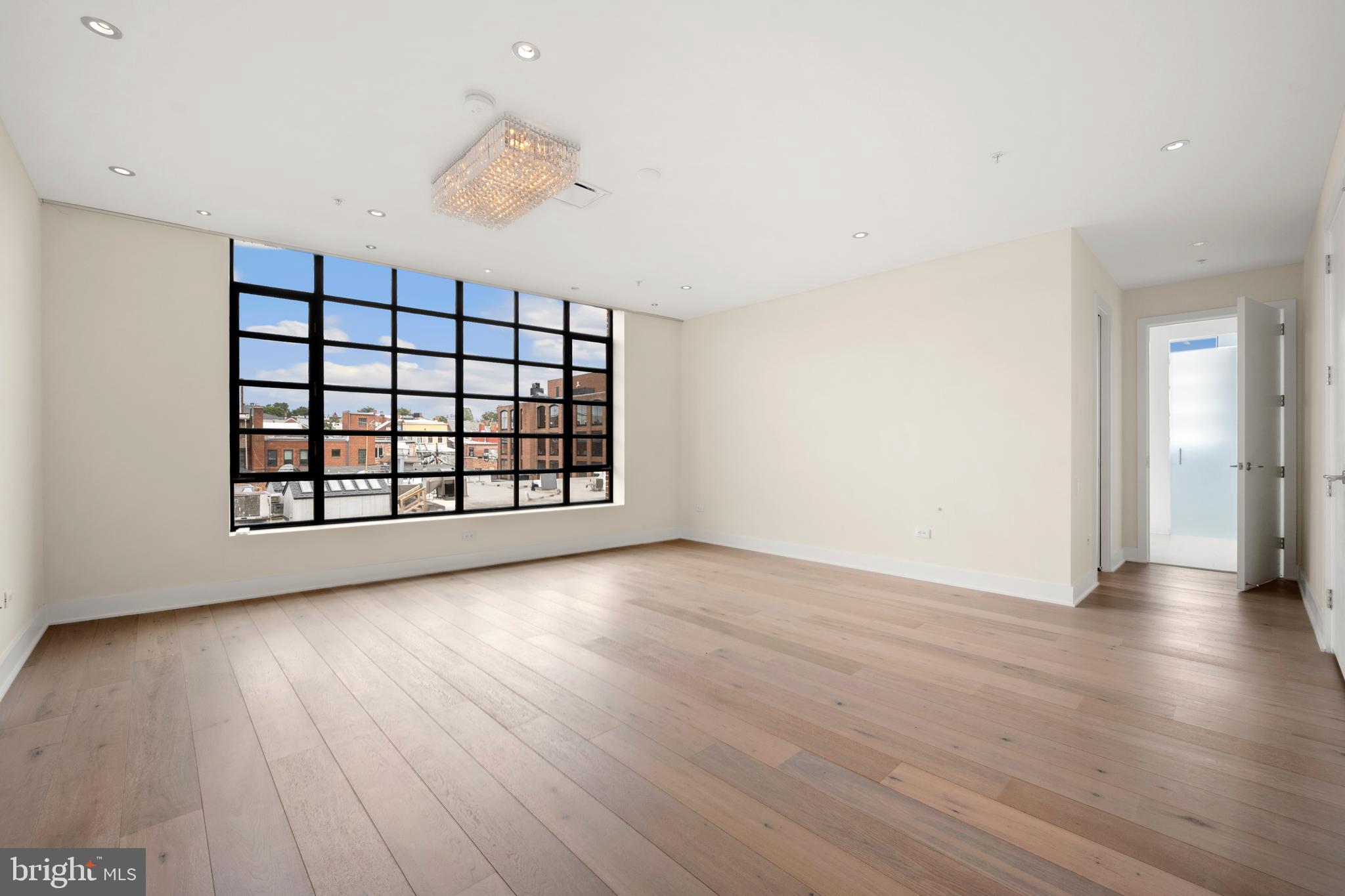 1055 Wisconsin Avenue Northwest, Unit 4E Washington, DC 20007 - Photo 19 of 58 wooden floor in an empty room with a window