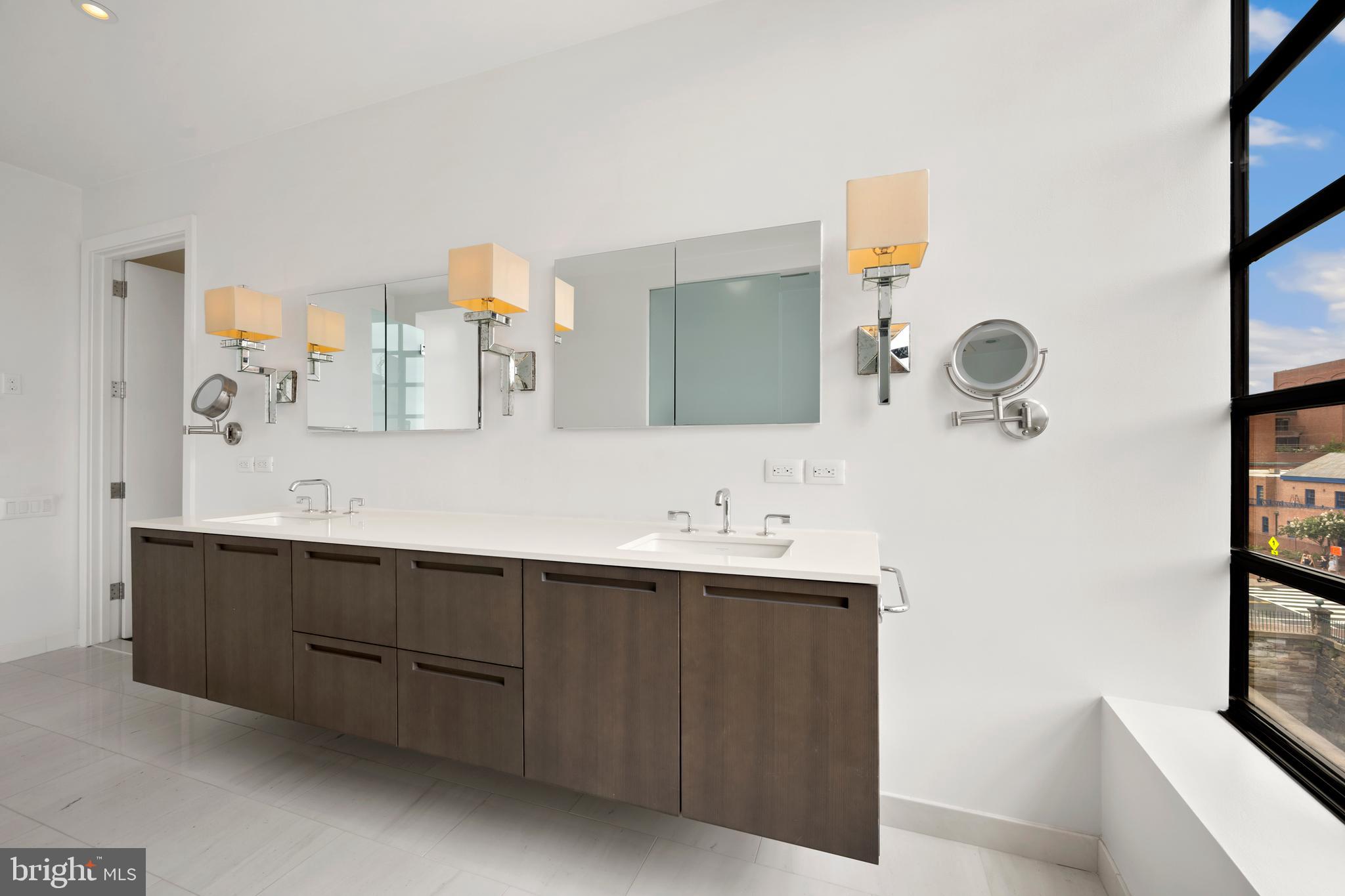 1055 Wisconsin Avenue Northwest, Unit 4E Washington, DC 20007 - Photo 22 of 58 a bathroom with a double vanity sink mirror and