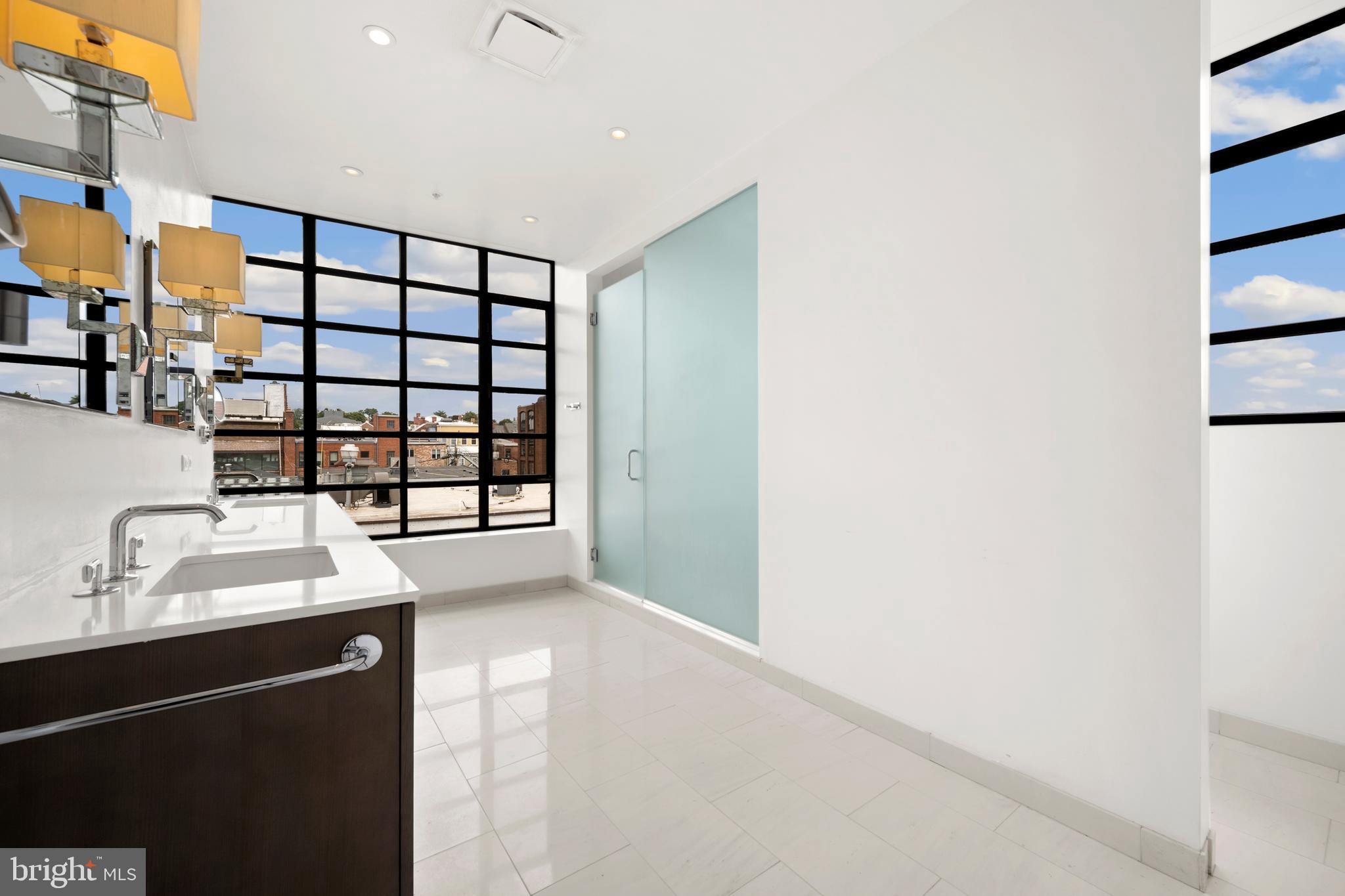 1055 Wisconsin Avenue Northwest, Unit 4E Washington, DC 20007 - Photo 23 of 58 a bathroom with a sink and a mirror