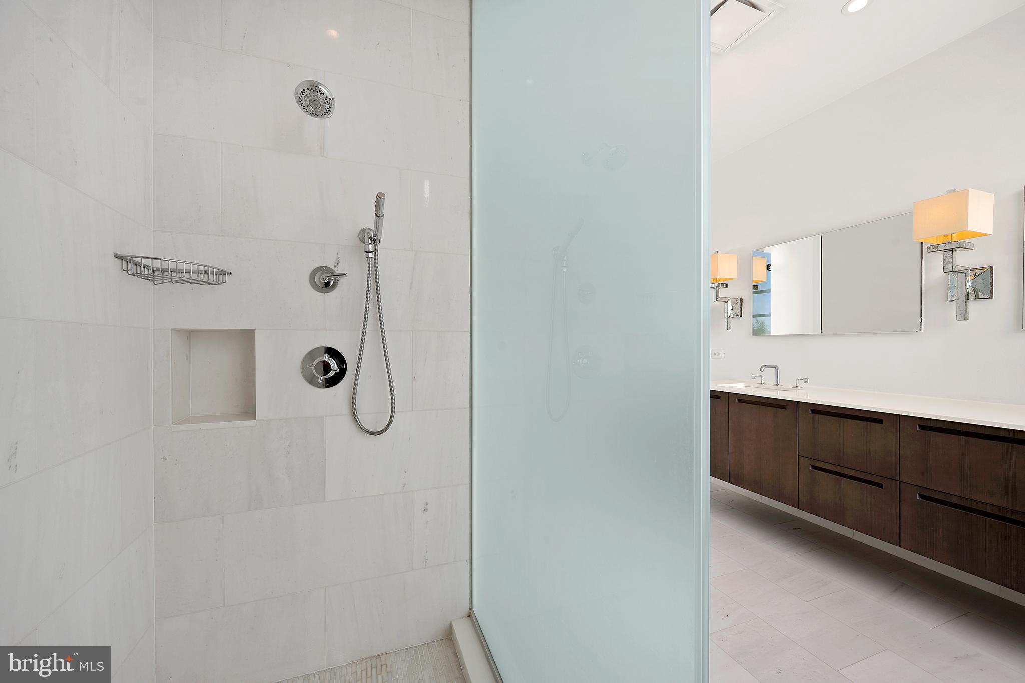 1055 Wisconsin Avenue Northwest, Unit 4E Washington, DC 20007 - Photo 25 of 58 a bathroom with a shower tub and a sink