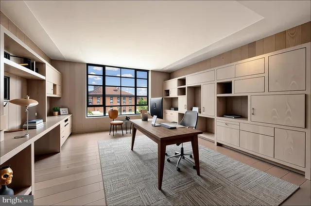 a living room with furniture a flat screen tv and a refrigerator