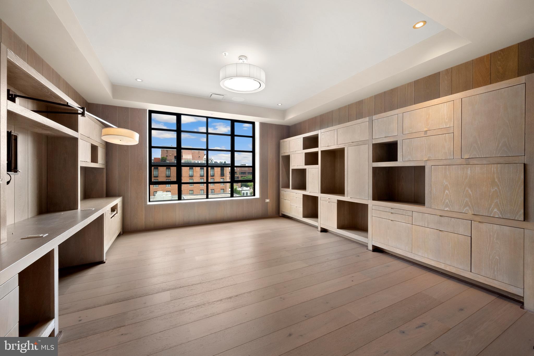 1055 Wisconsin Avenue Northwest, Unit 4E Washington, DC 20007 - Photo 29 of 58 a view of an empty room with a window and cabinet