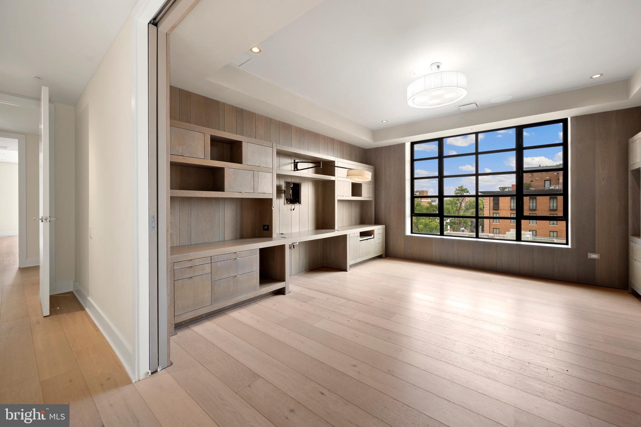 1055 Wisconsin Avenue Northwest, Unit 4E Washington, DC 20007 - Photo 30 of 58 a view of an empty room with window and cabinet