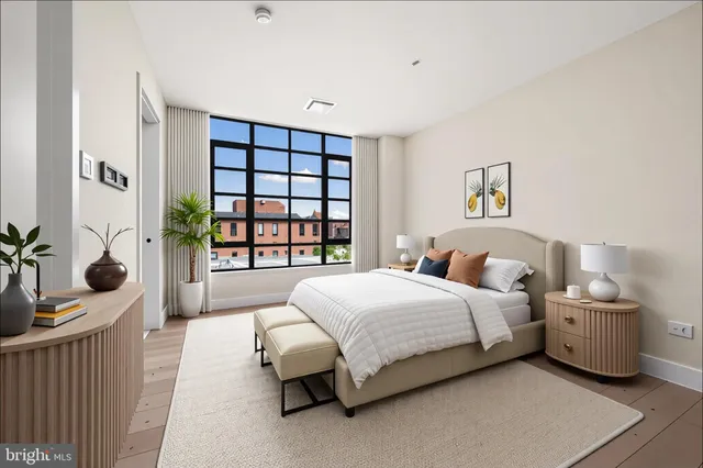 a bedroom with a bed and a large window