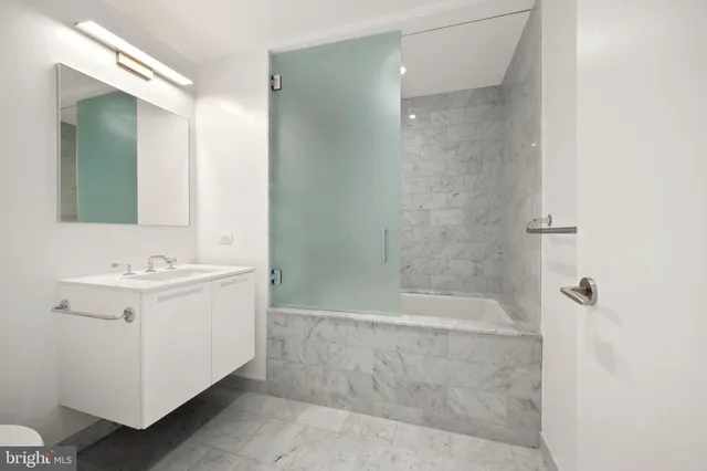 a bedroom with a large bed and a large window