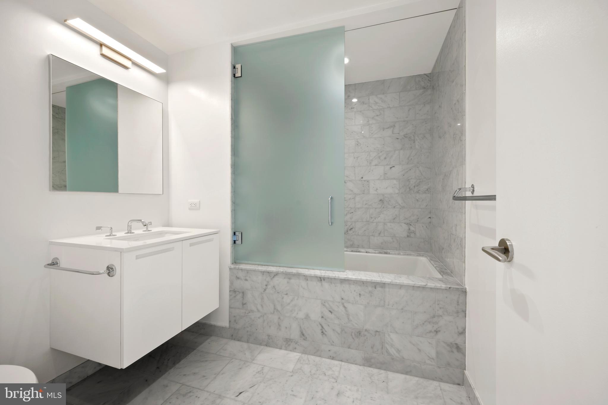 1055 Wisconsin Avenue Northwest, Unit 4E Washington, DC 20007 - Photo 38 of 58 a bathroom with a sink a toilet and shower