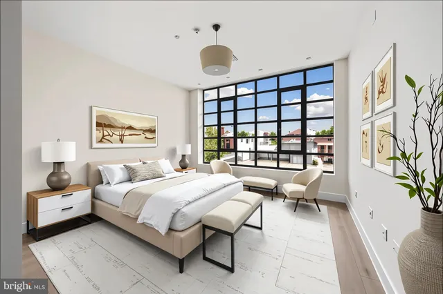a view of a room with wooden floor and white walls