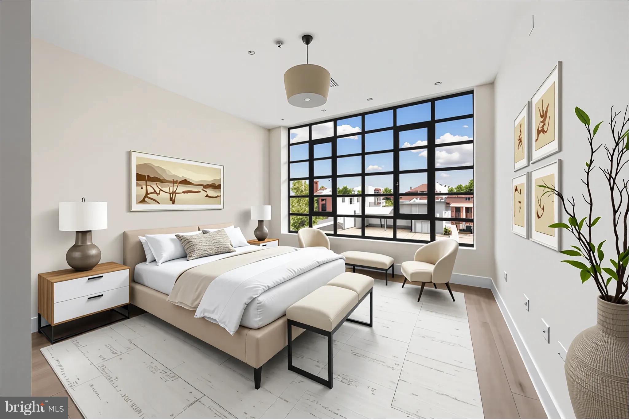 1055 Wisconsin Avenue Northwest, Unit 4E Washington, DC 20007 - Photo 39 of 58 a bedroom with a large bed and a large window