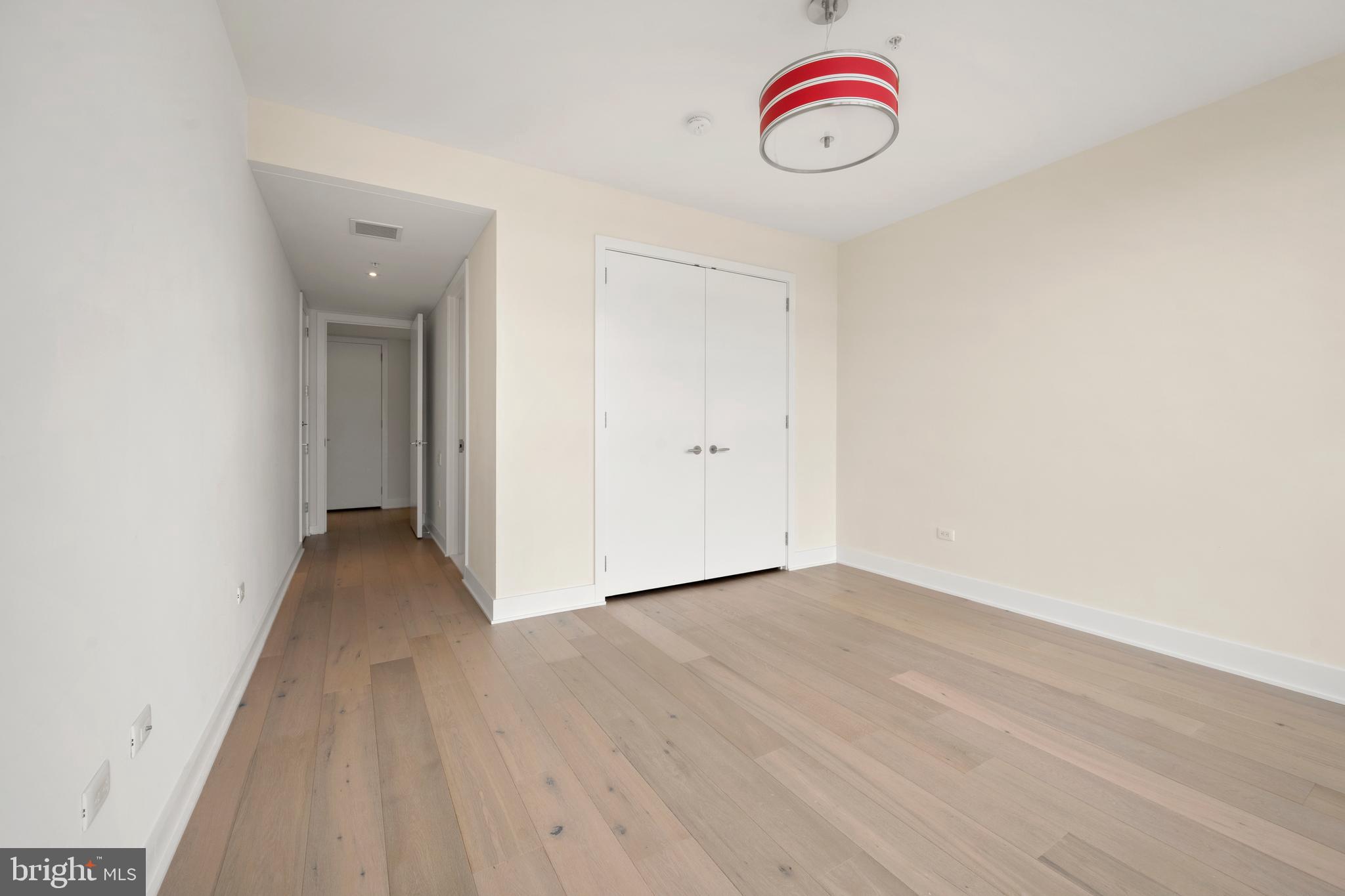 1055 Wisconsin Avenue Northwest, Unit 4E Washington, DC 20007 - Photo 40 of 58 a view of a room with wooden floor and white walls