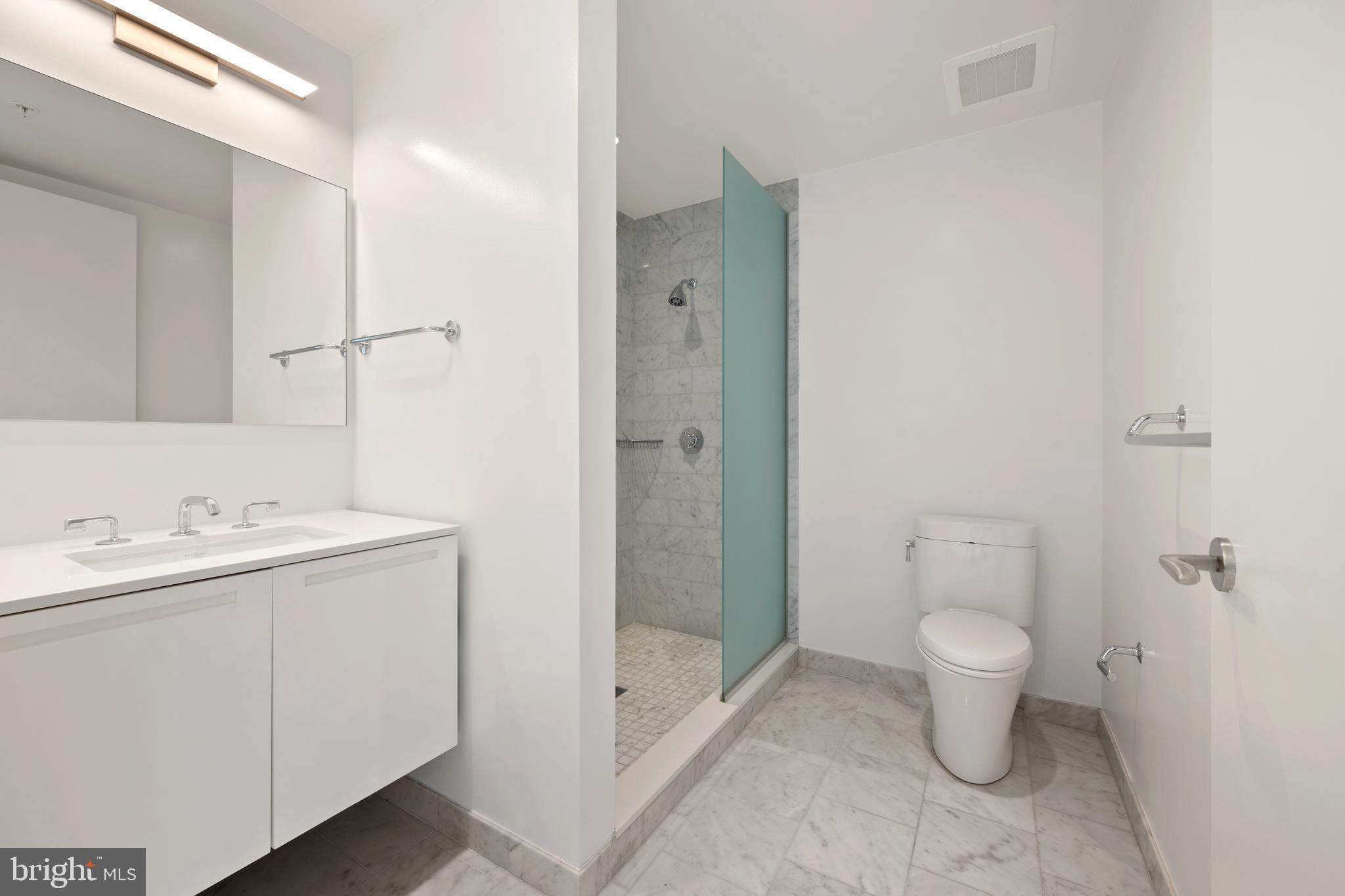 1055 Wisconsin Avenue Northwest, Unit 4E Washington, DC 20007 - Photo 41 of 58 a bathroom with a sink a toilet and shower