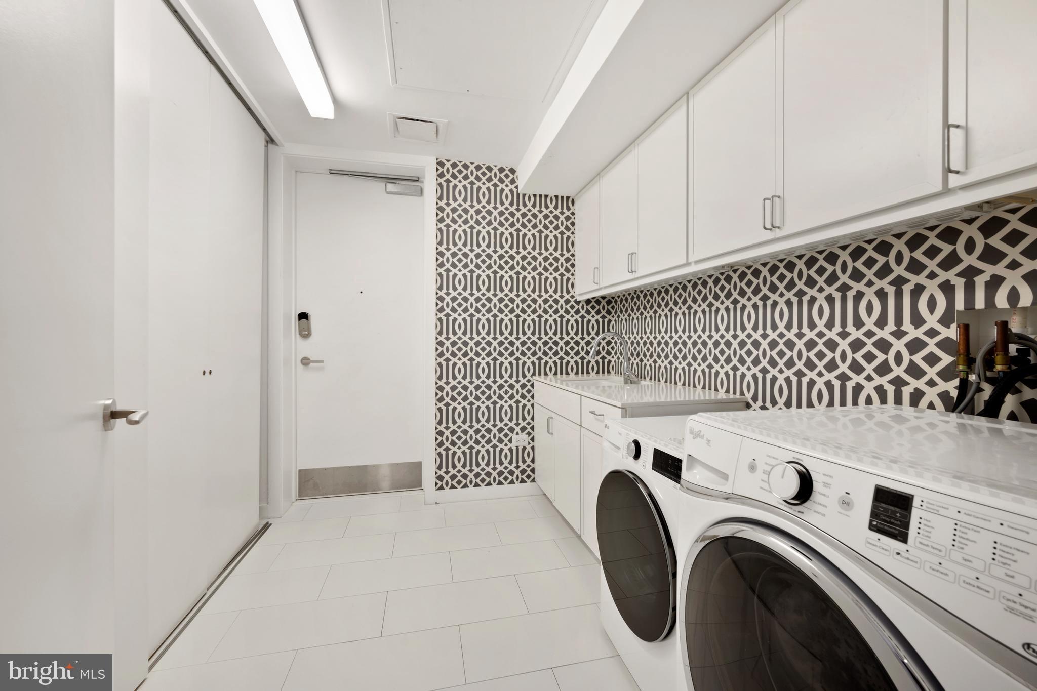 1055 Wisconsin Avenue Northwest, Unit 4E Washington, DC 20007 - Photo 44 of 58 a utility room with dryer and washer