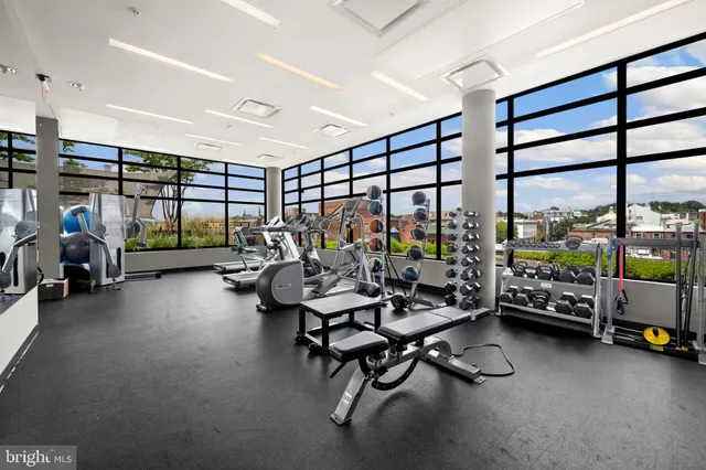 a view of a patio with couches table and chairs and potted plants