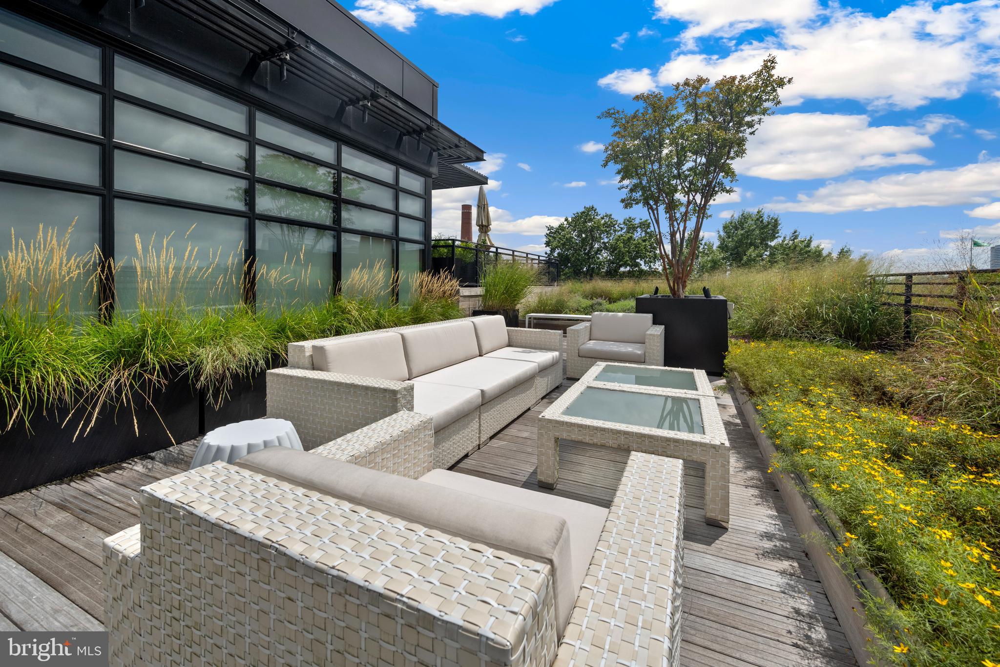 1055 Wisconsin Avenue Northwest, Unit 4E Washington, DC 20007 - Photo 49 of 58 a view of a patio with couches table and chairs and potted plants