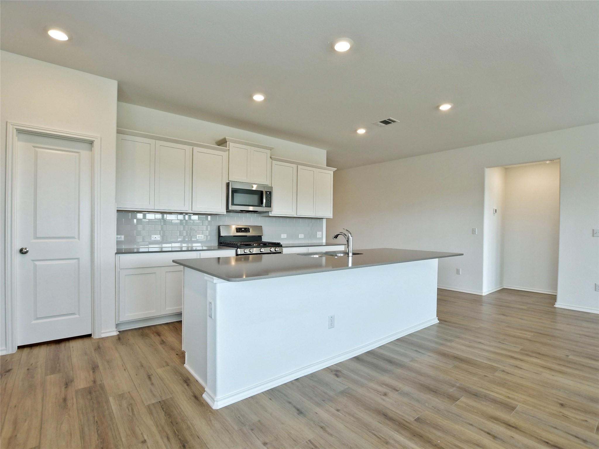 229 Vortex Pass Kyle, TX 78640 - Photo 12 of 32 a kitchen with stainless steel appliances a refrigerator sink and cabinets