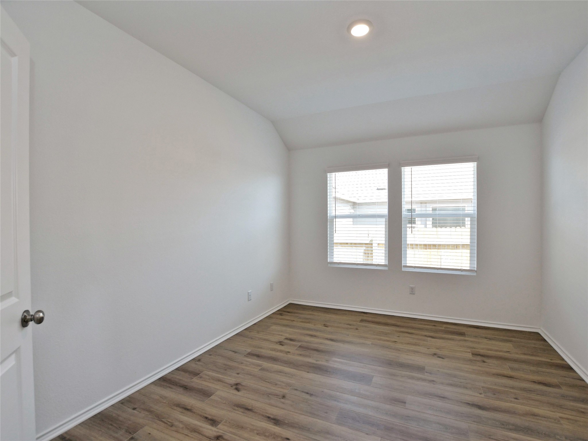 229 Vortex Pass Kyle, TX 78640 - Photo 15 of 32 an empty room with wooden floor and windows
