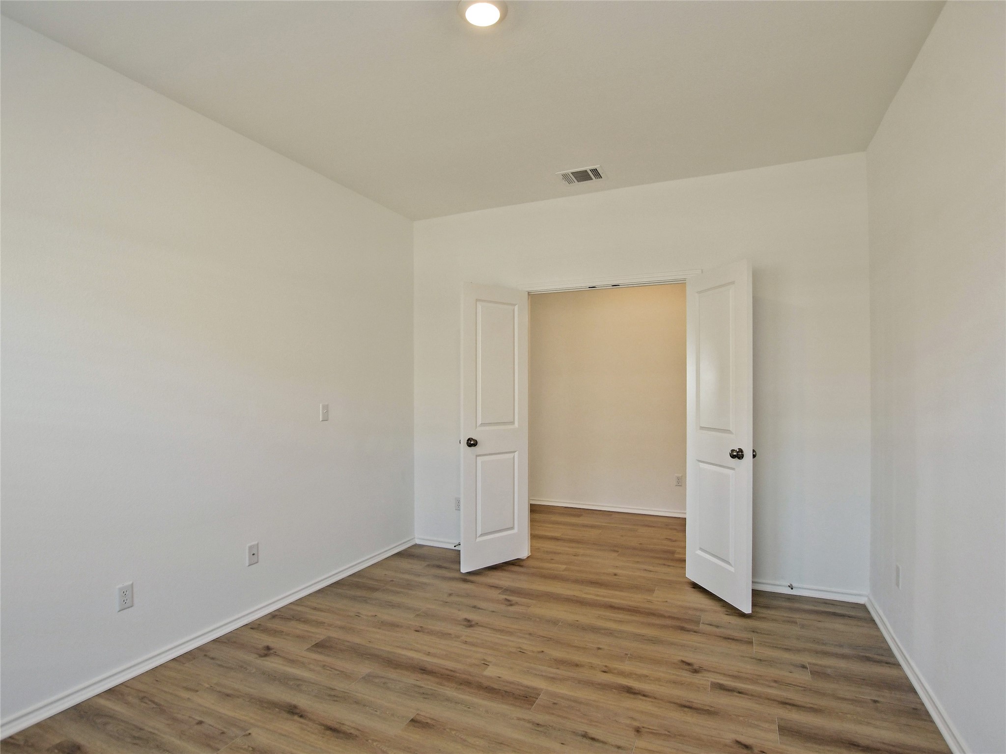 229 Vortex Pass Kyle, TX 78640 - Photo 16 of 32 a view of an empty room and wooden floor