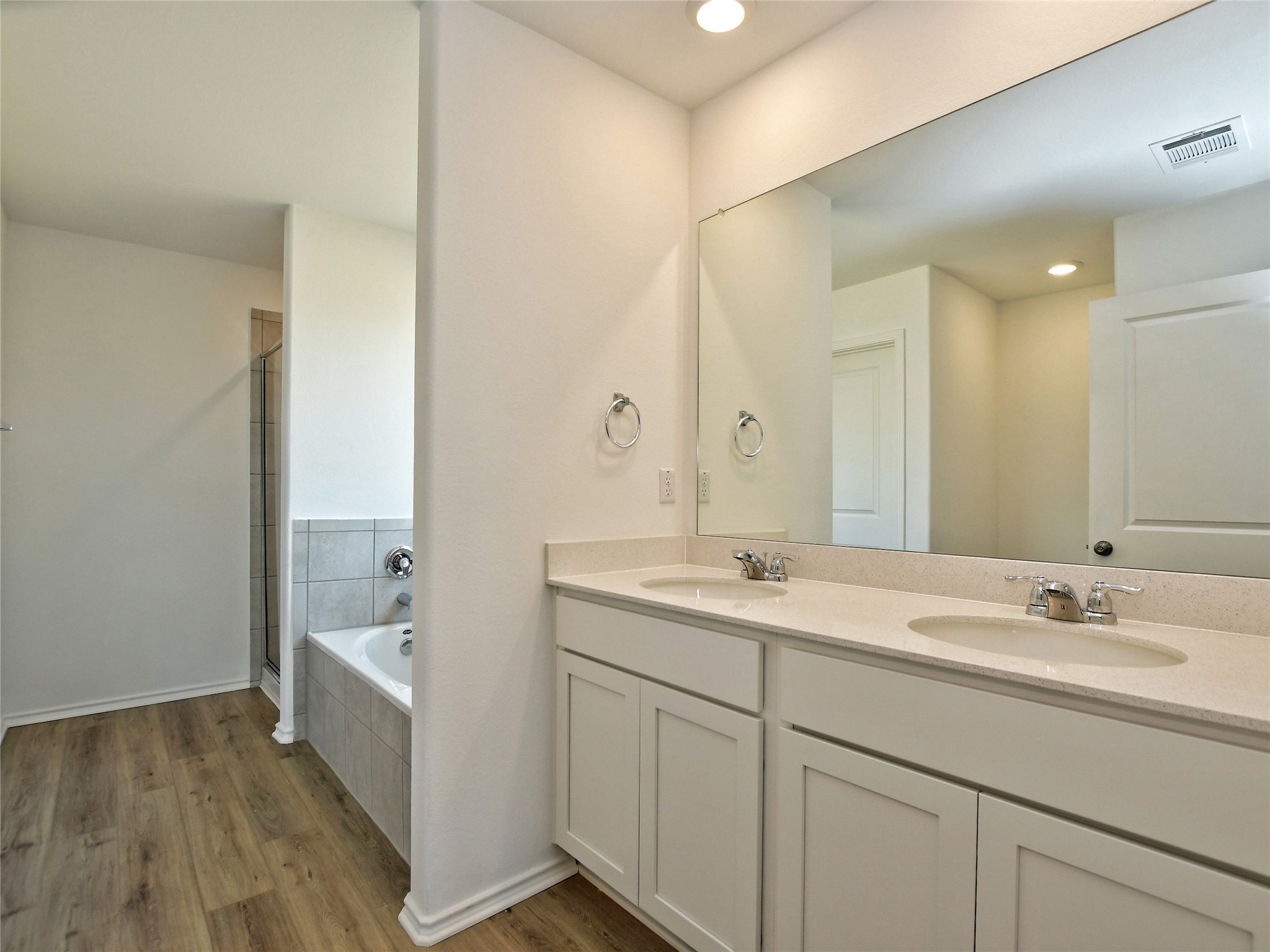 229 Vortex Pass Kyle, TX 78640 - Photo 19 of 32 a bathroom with a sink a mirror and a bathtub