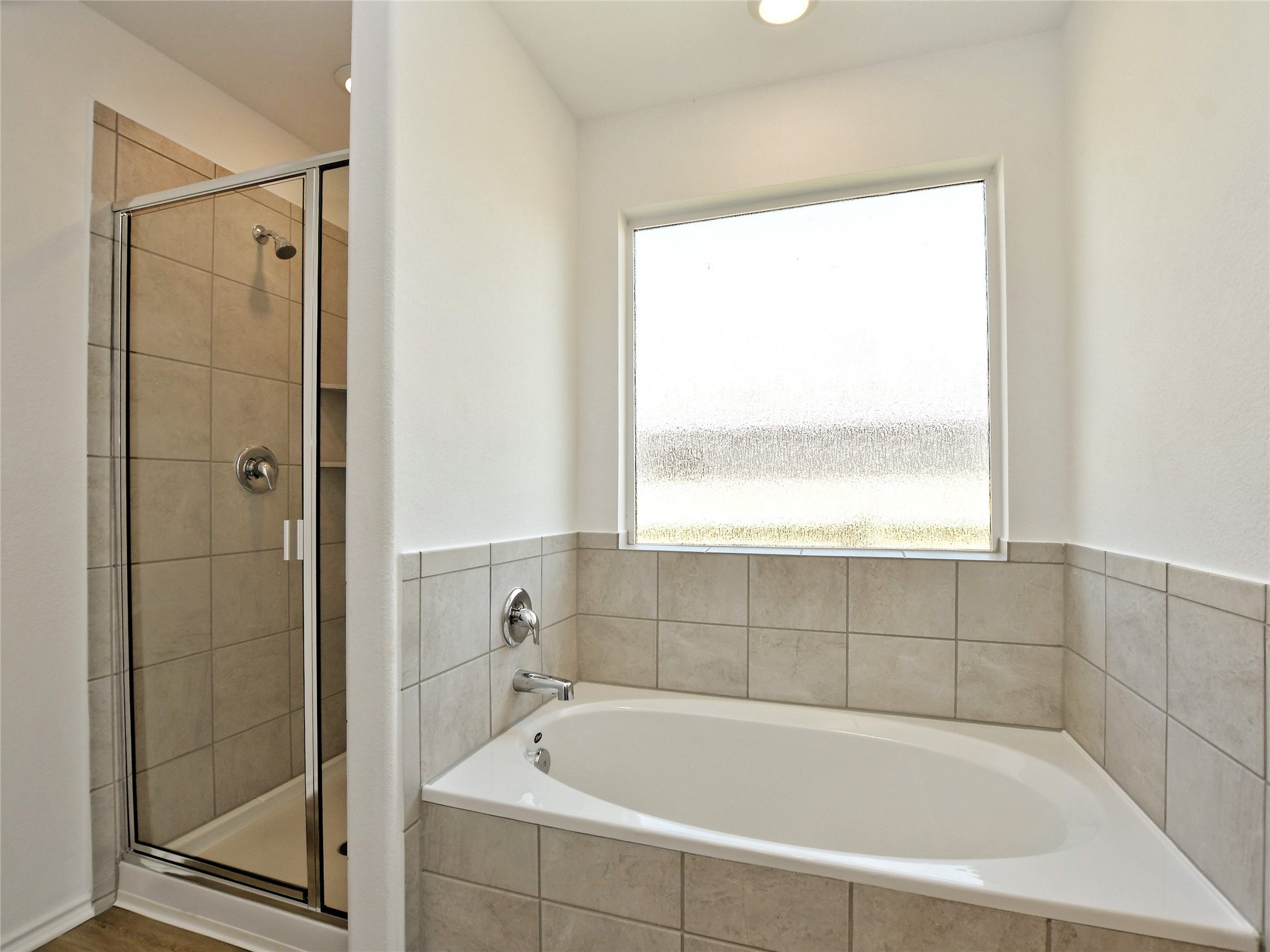 229 Vortex Pass Kyle, TX 78640 - Photo 20 of 32 a white bath tub sitting next to a shower