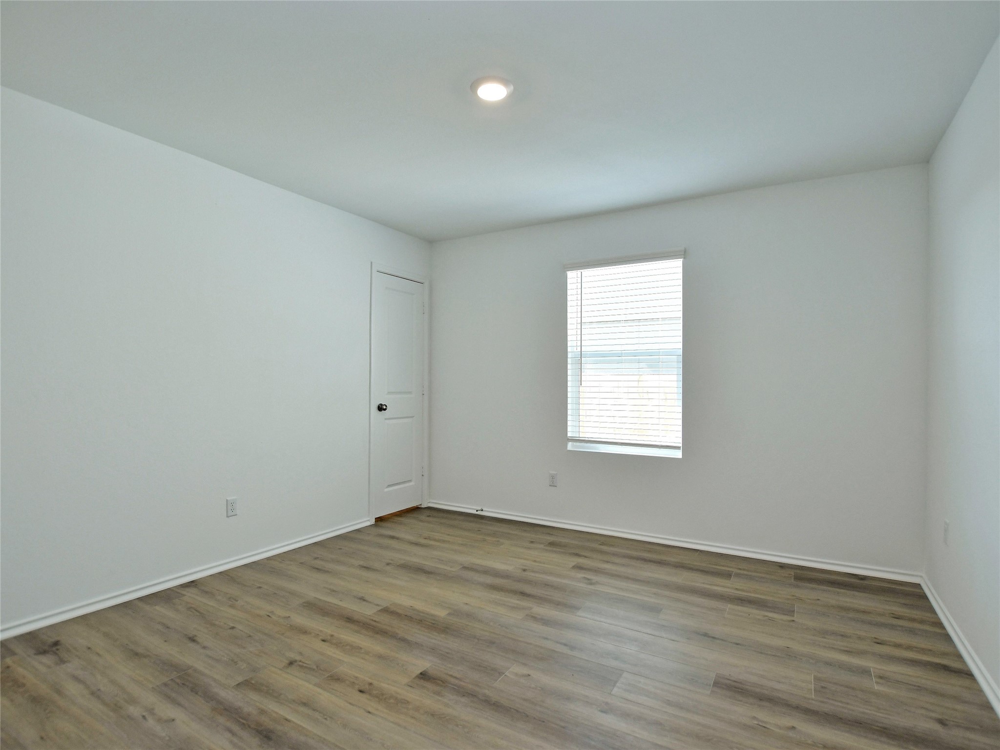229 Vortex Pass Kyle, TX 78640 - Photo 25 of 32 wooden floor in an empty room with a window