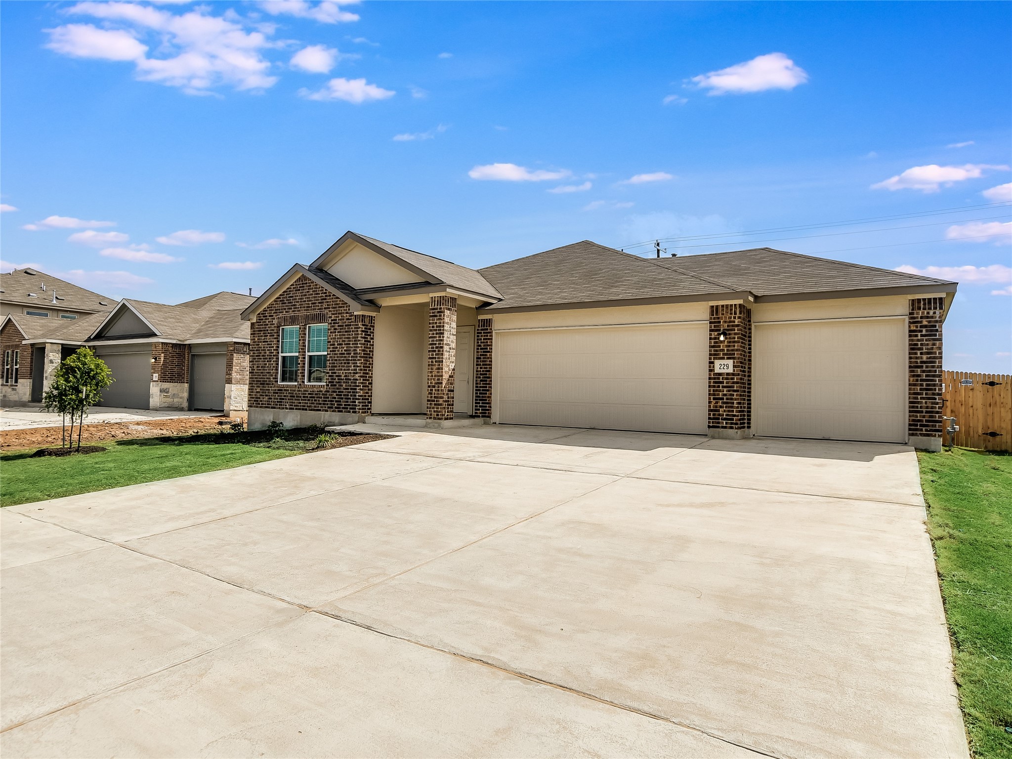 229 Vortex Pass Kyle, TX 78640 - Photo 3 of 32 a front view of a house with a yard and garage