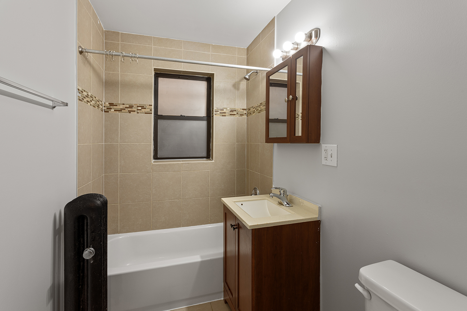 1702 West Juneway Terrace, Unit 2C Chicago, IL 60626 - Photo 12 of 16 a bathroom with a sink and mirror with toilet