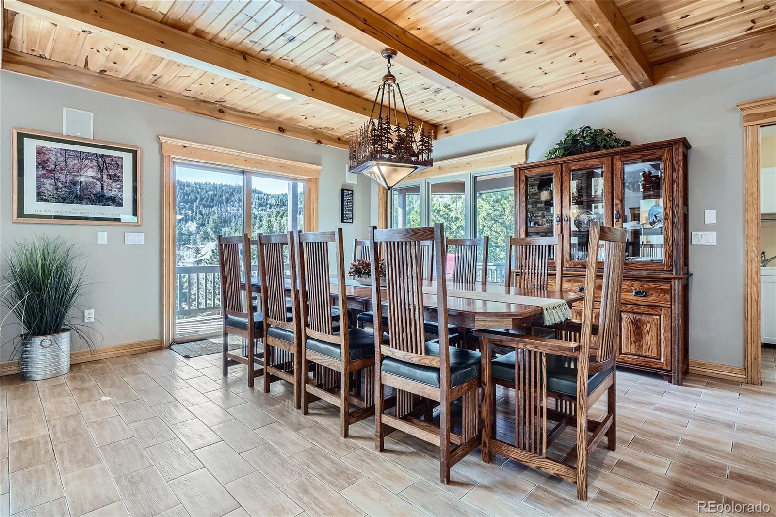 9659 South Turkey Creek Road Morrison, CO 80465 - Photo 11 of 48 a view of a dining room with furniture window and wooden floor