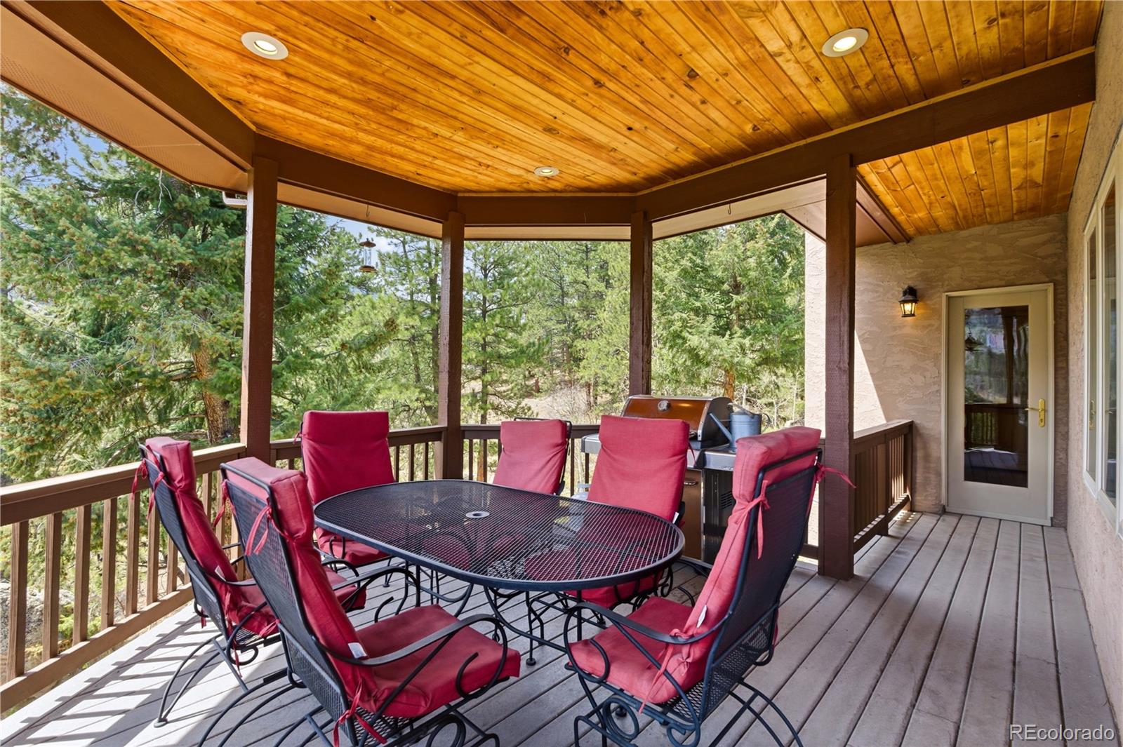 9659 South Turkey Creek Road Morrison, CO 80465 - Photo 13 of 49 a view of a dining room with furniture window and wooden floor