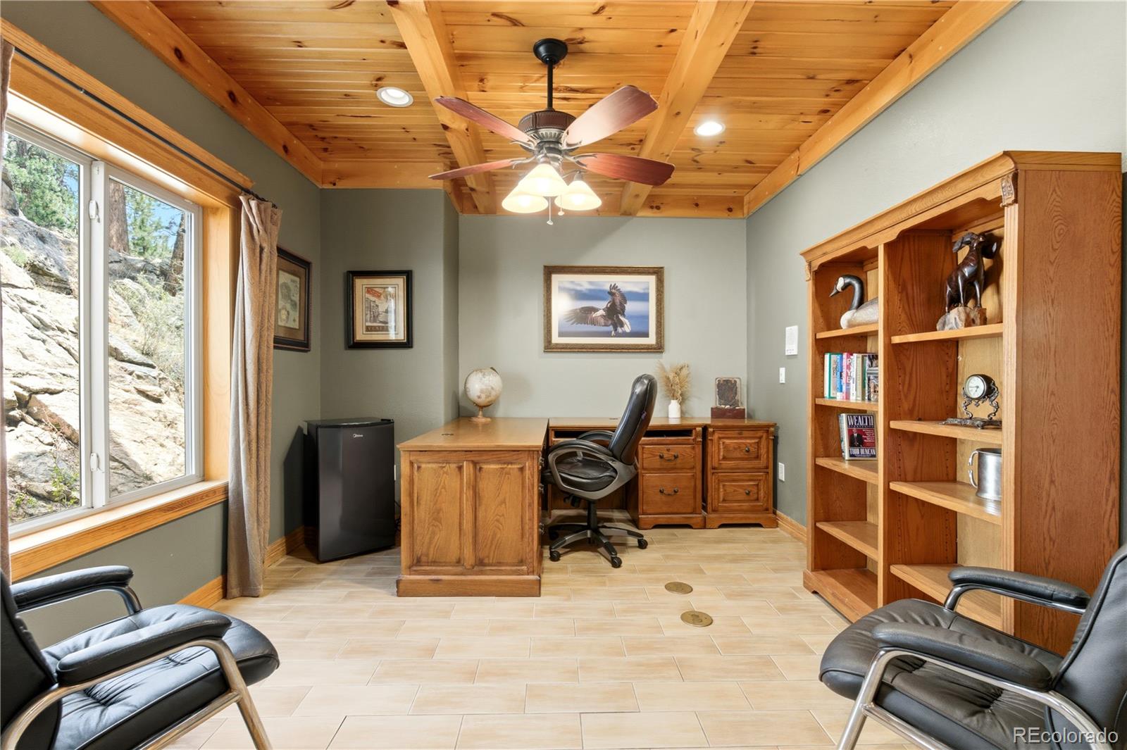 9659 South Turkey Creek Road Morrison, CO 80465 - Photo 14 of 49 a view of a livingroom with workspace and a window