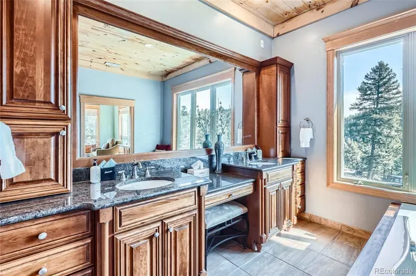 a kitchen with a granite countertop sink and a large window
