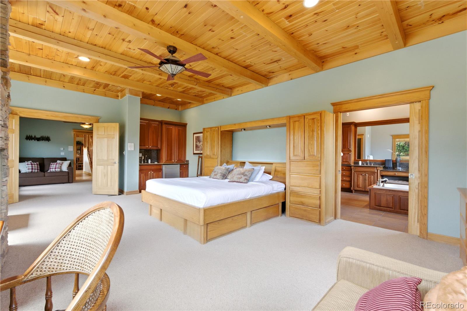 9659 South Turkey Creek Road Morrison, CO 80465 - Photo 20 of 49 a bedroom with a bed and wooden floor