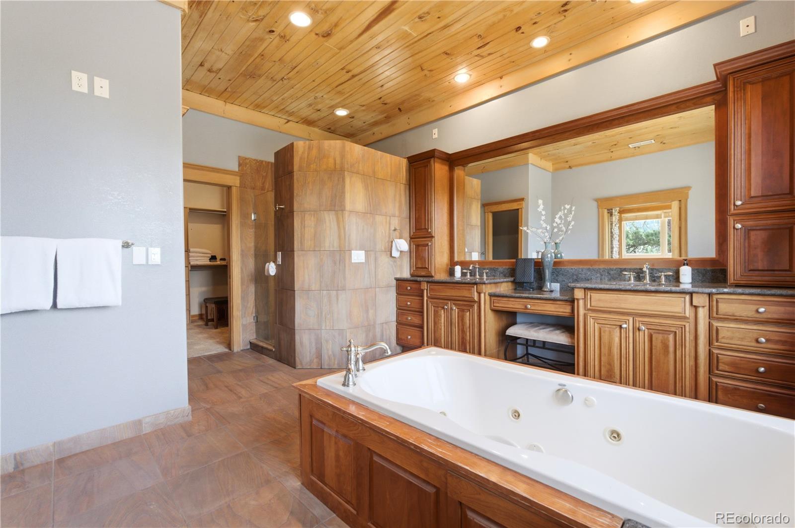 9659 South Turkey Creek Road Morrison, CO 80465 - Photo 25 of 49 a large white kitchen with a large window and stainless steel appliances
